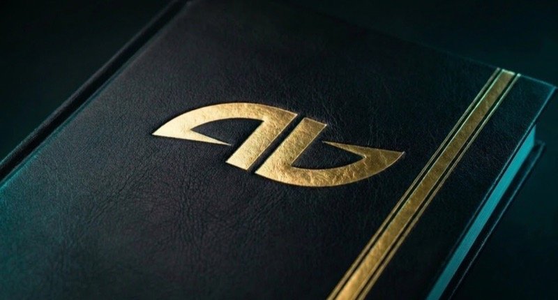 Księga marki AD AWARDS — złote tłoczenie logo, pas złotej folii